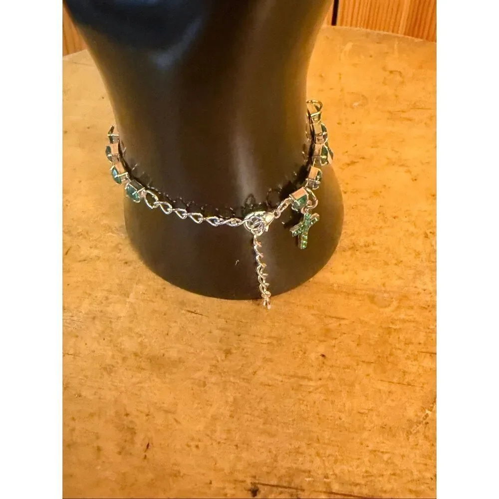 silver-toned bracelet cross charms link segments set emerald-colored crystals (7
